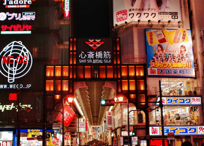 Shinsaibashi-suji Shopping Street, welcoming in guests with bright signs and lights.